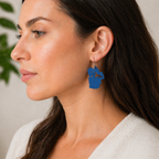 Blue Lake Tahoe earrings with mountain cutout worn by woman, cobalt blue sculpted dangle earrings, close up view